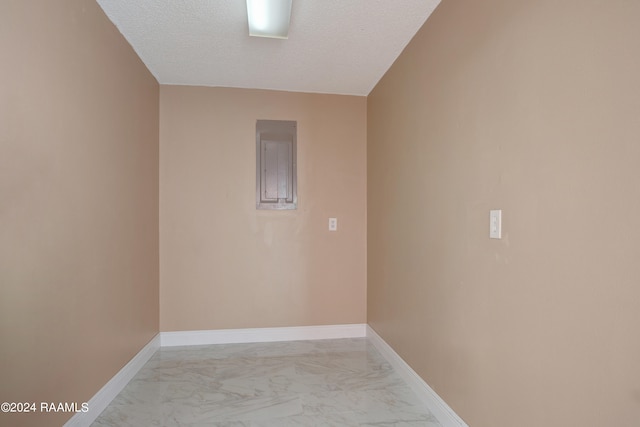 tiled spare room with a textured ceiling