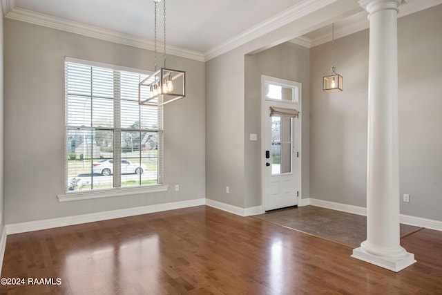 entrance foyer featuring ornamental molding, dark hardwood / wood-style floors, and ornate columns