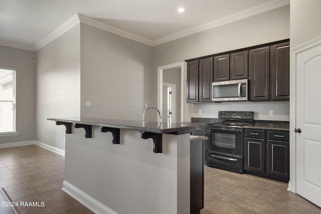 kitchen featuring a breakfast bar, black electric range oven, dark brown cabinets, crown molding, and light tile floors