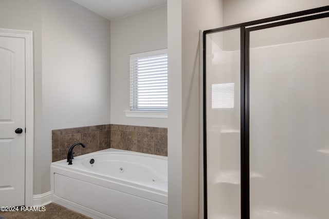 bathroom featuring plus walk in shower and tile floors