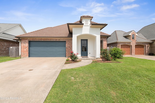 view of front of property featuring a garage and a front lawn