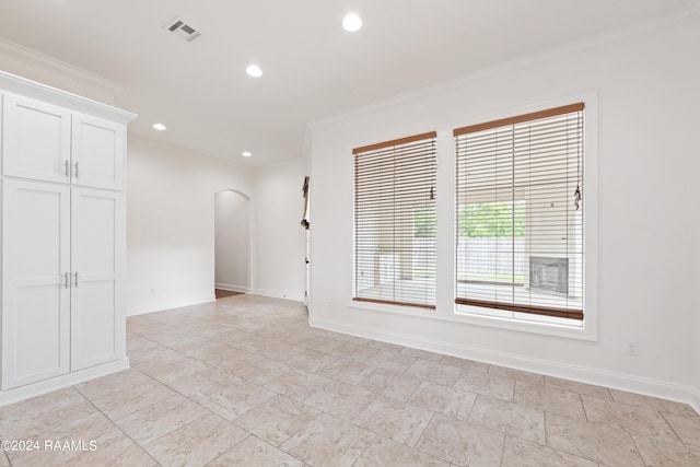 unfurnished room with crown molding