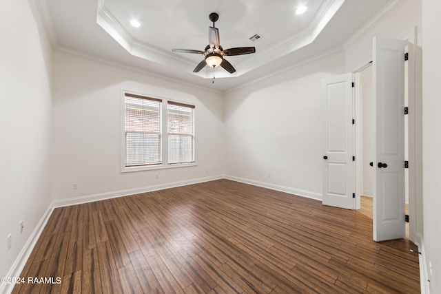 spare room with ceiling fan, ornamental molding, and a tray ceiling