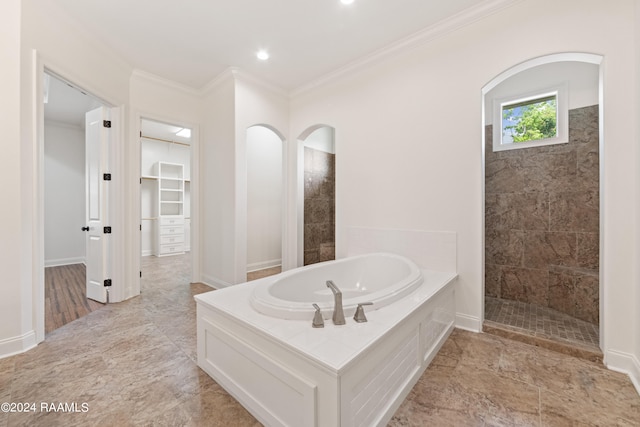 bathroom featuring crown molding and independent shower and bath