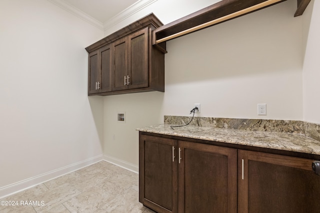 clothes washing area featuring cabinets, hookup for a washing machine, and crown molding