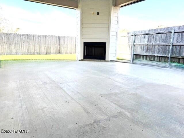 view of patio with a fireplace