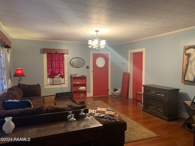 living room with a chandelier, hardwood / wood-style floors, and crown molding