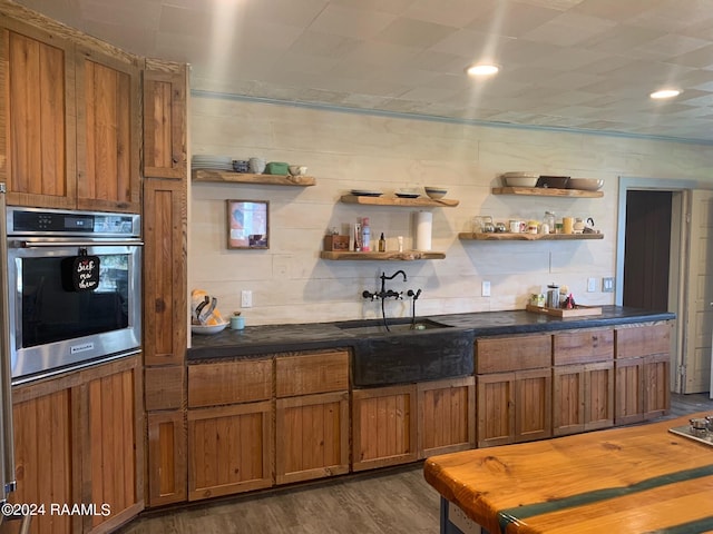 bar with oven, backsplash, sink, and dark hardwood / wood-style floors