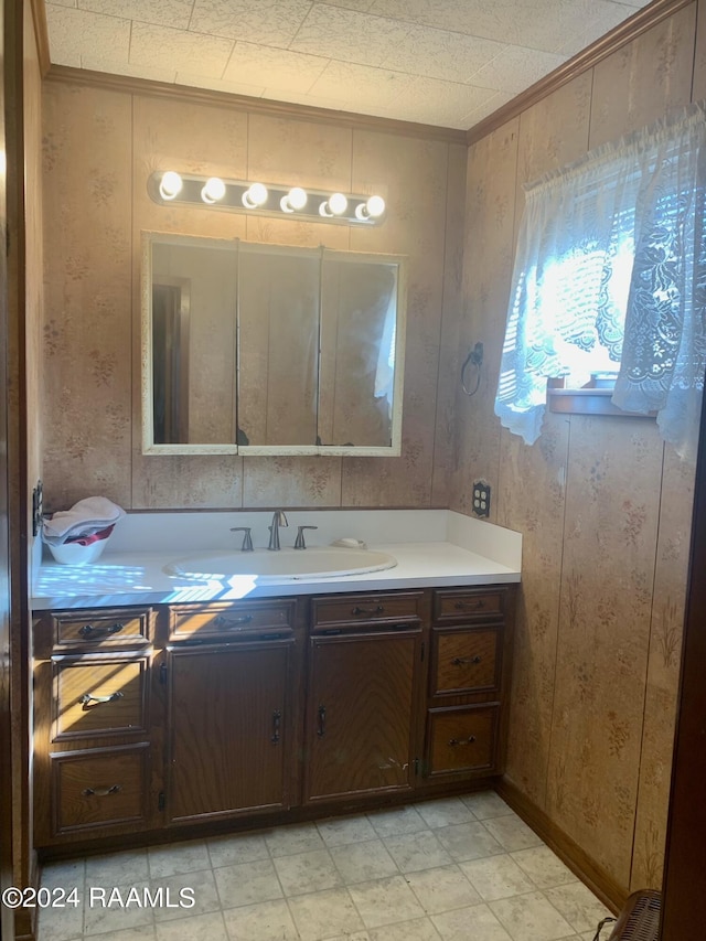 bathroom with vanity, tile floors, wood walls, and crown molding