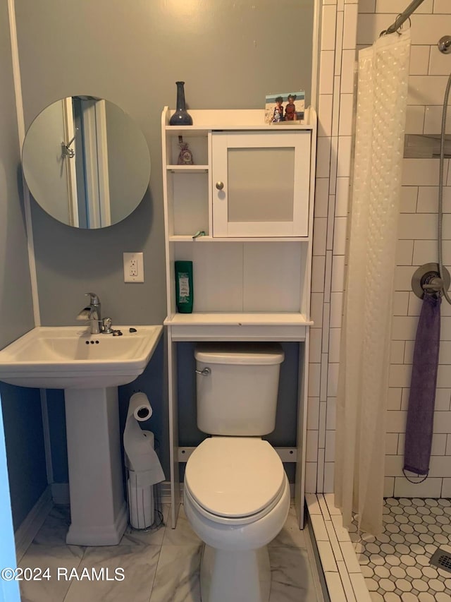 bathroom with sink, walk in shower, tile flooring, and toilet