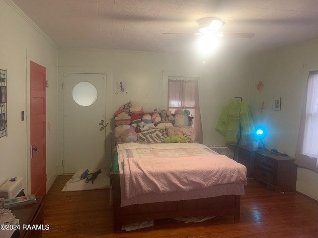 bedroom with ceiling fan and dark wood-type flooring