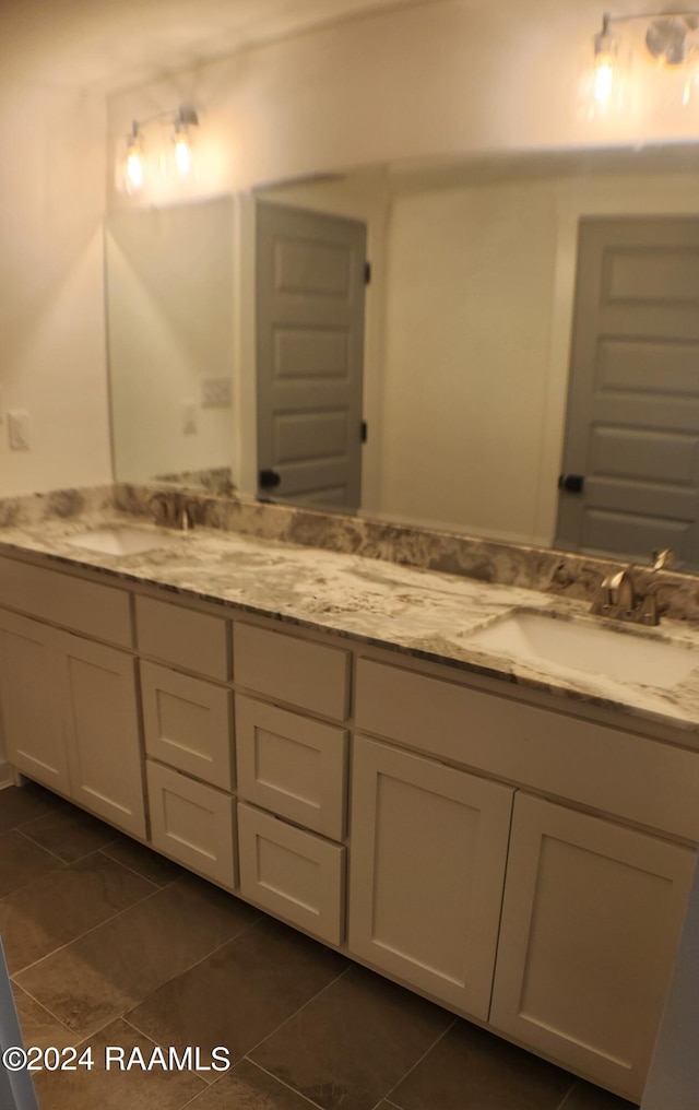 bathroom with tile patterned flooring and vanity