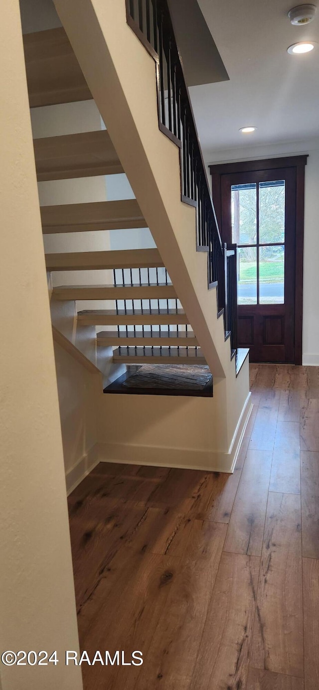 stairs with hardwood / wood-style flooring