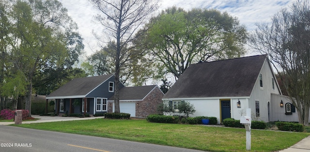 view of front of home with a garage and a front lawn