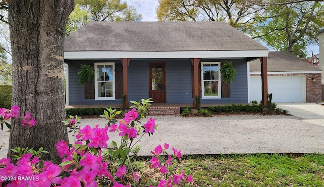 bungalow-style home with a garage and covered porch