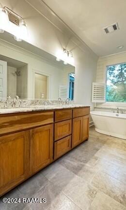 bathroom featuring crown molding, vanity, and a bath