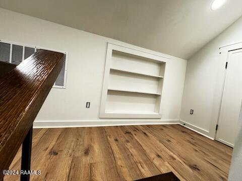 interior space featuring lofted ceiling and hardwood / wood-style flooring