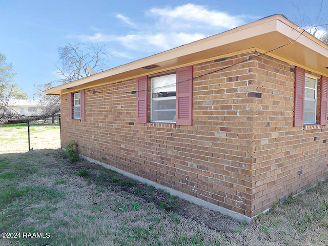 view of property exterior with a yard