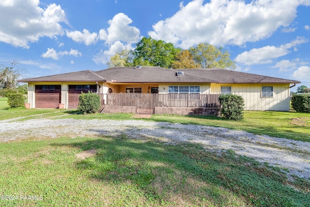 single story home featuring a front lawn and a garage