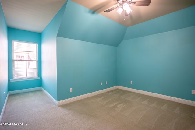 bonus room with lofted ceiling, ceiling fan, and light colored carpet