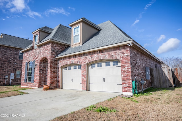 view of front of property with a front lawn and a garage