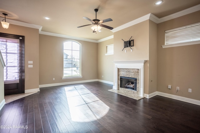 unfurnished living room with a high end fireplace, ceiling fan, and dark hardwood / wood-style flooring