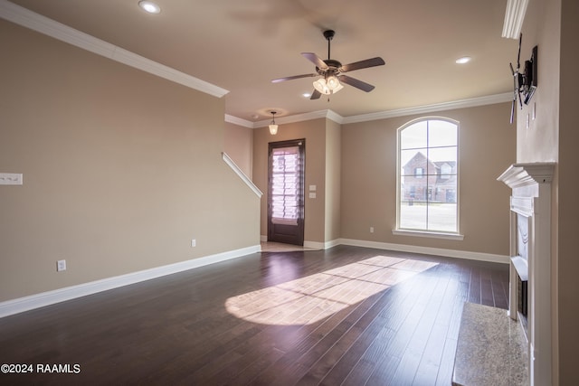 unfurnished living room featuring dark hardwood / wood-style flooring, ceiling fan, and ornamental molding