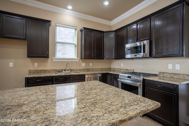 kitchen featuring dark brown cabinetry, light stone counters, stainless steel appliances, sink, and ornamental molding