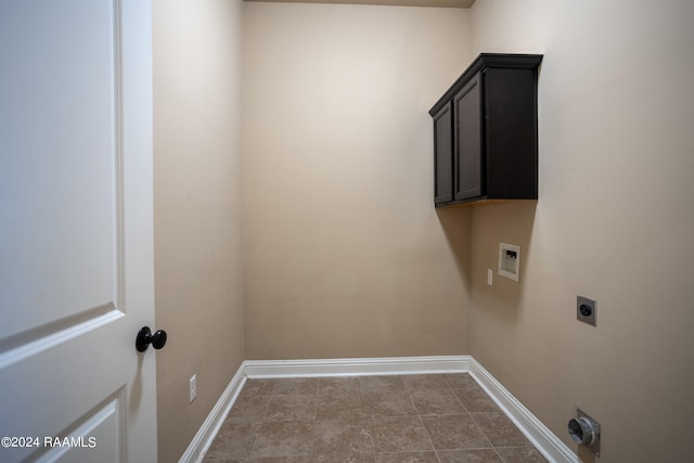 laundry room with cabinets, electric dryer hookup, and tile flooring