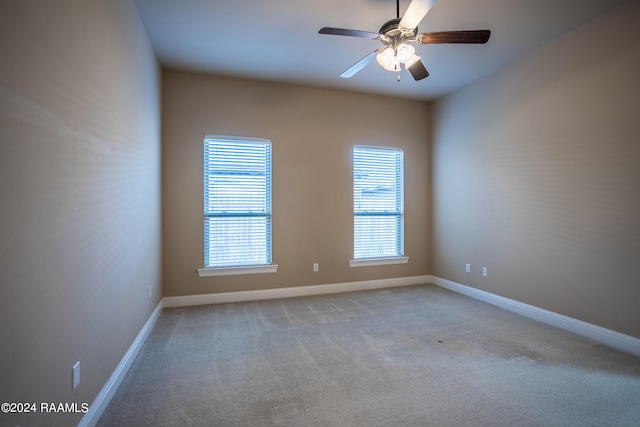 carpeted empty room featuring ceiling fan