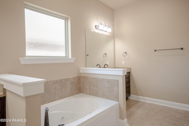 bathroom with a bathing tub, tile floors, and vanity