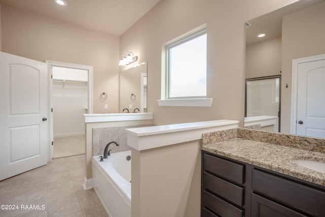 bathroom with tile flooring, a bathing tub, and oversized vanity