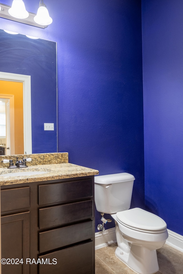 bathroom featuring oversized vanity, toilet, and tile flooring