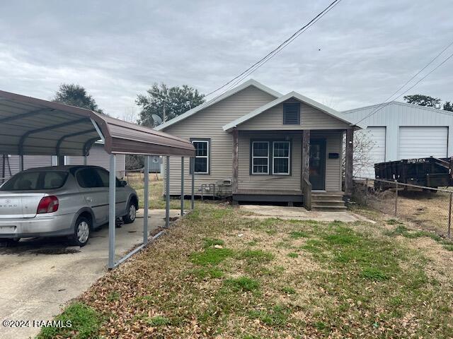 view of front of house with a garage and a carport