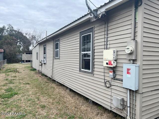 view of side of property with a lawn