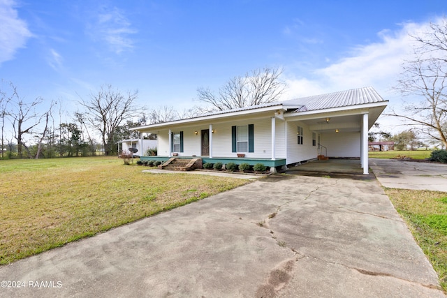 ranch-style house featuring a porch, a carport, and a front yard