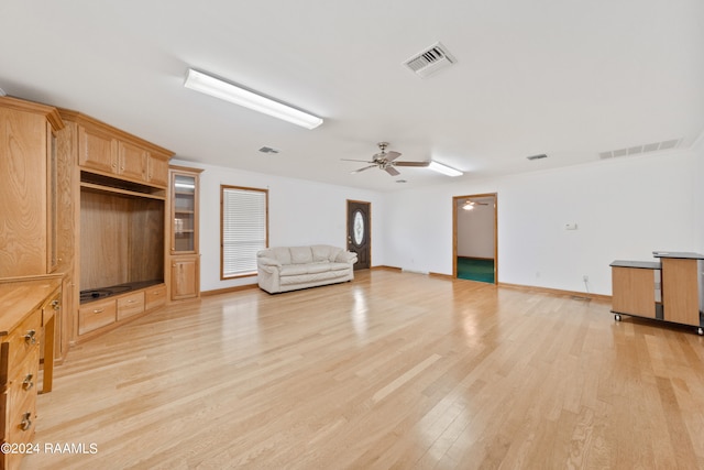 unfurnished living room with ceiling fan and light hardwood / wood-style flooring