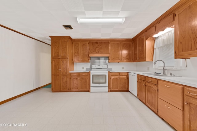 kitchen with range, crown molding, light tile floors, sink, and white dishwasher