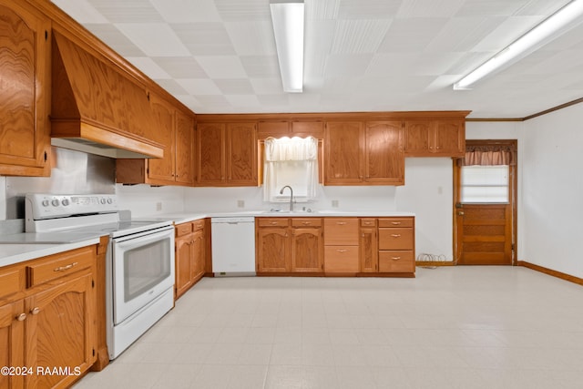 kitchen featuring white appliances, sink, light tile floors, custom range hood, and ornamental molding