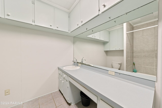 laundry area featuring sink and light tile floors