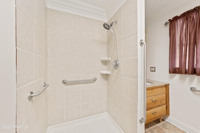 bathroom with tile flooring, ornamental molding, vanity, and tiled shower