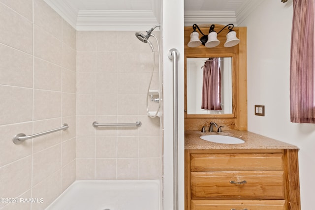 bathroom with ornamental molding, a tile shower, and oversized vanity