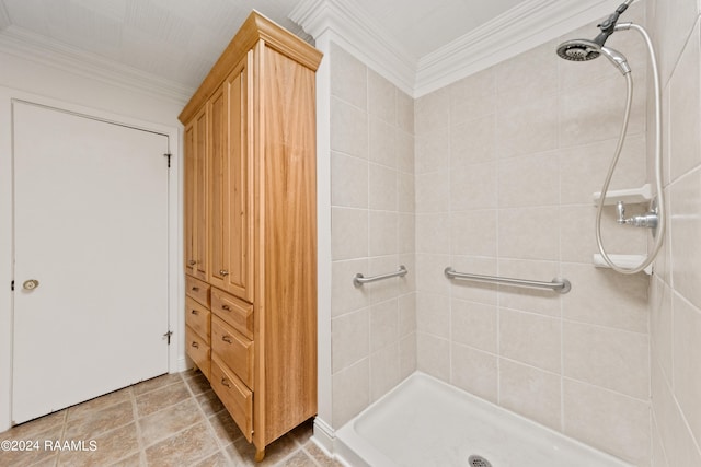 bathroom featuring ornamental molding, tile flooring, and tiled shower