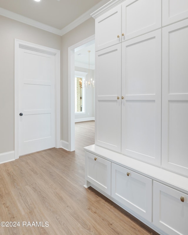 mudroom featuring a chandelier, ornamental molding, and light hardwood / wood-style floors