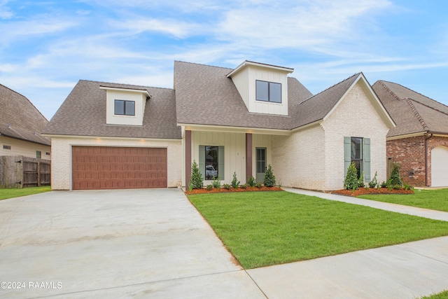 view of front of property with a front lawn and a garage