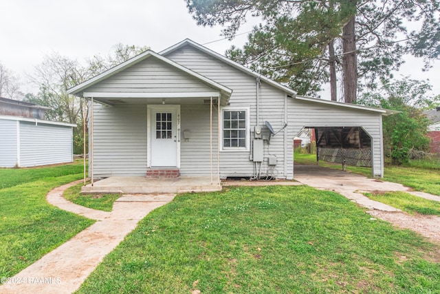 bungalow-style home featuring a front yard and a carport