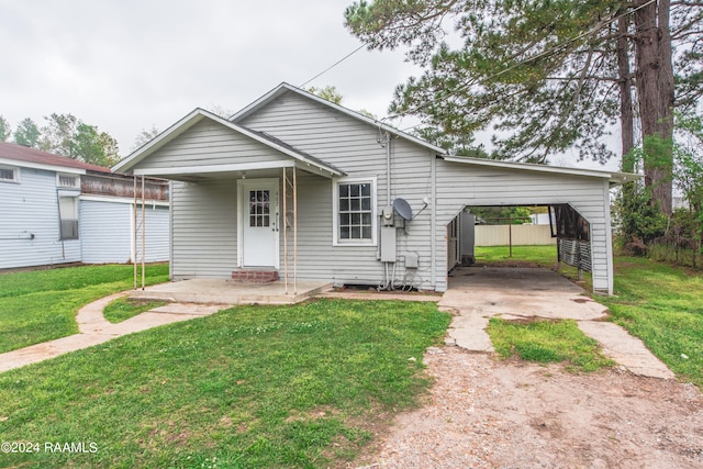 bungalow-style home with a front yard and a carport