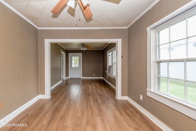 unfurnished room with a healthy amount of sunlight, ceiling fan, and light wood-type flooring