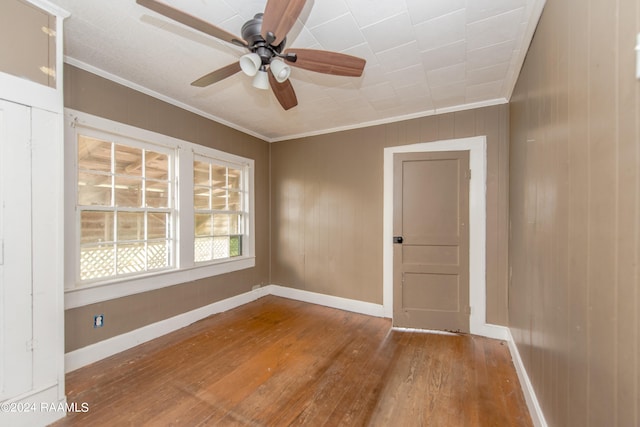 spare room with dark hardwood / wood-style flooring, ceiling fan, and ornamental molding