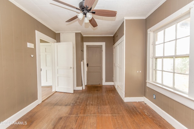 hall with light hardwood / wood-style flooring and crown molding